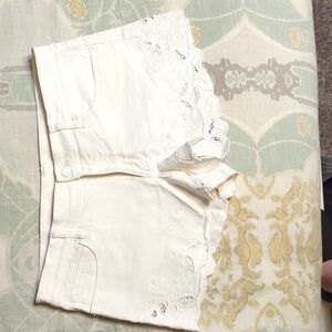 Women's size 12 white denim shorts with cutouts around leg